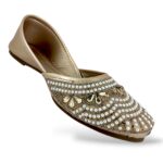Women's flat juttis wholesale featuring intricate pearl and rhinestone floral embellishments on a classic ethnic flat shoe.