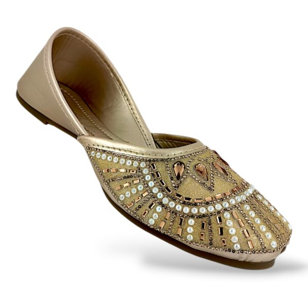 Traditional women's flat juttis wholesale with intricate pearl embellishments and detailed beadwork on the upper.