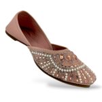Traditional women's flat juttis wholesale with intricate pearl embellishments and detailed beadwork on the upper.