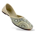 Elegant traditional ethnic footwear from our women's juttis wholesale collection featuring intricate pearl embroidery and crystal embellishments on a flat sole.