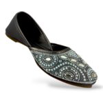 Elegant traditional ethnic footwear from our women's juttis wholesale collection featuring intricate pearl embroidery and crystal embellishments on a flat sole.