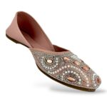 Elegant traditional ethnic footwear from our women's juttis wholesale collection featuring intricate pearl embroidery and crystal embellishments on a flat sole.