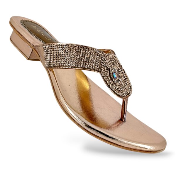 Women's low heel sandals wholesale featuring a metallic slip-on design with a rhinestone-embellished T-strap and a low block heel.